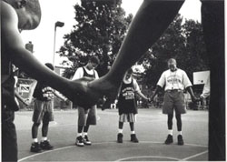 Jeff Bynoe, thirty-three (far right), leads a pregame prayer in Orchard Park, where he was born and raised.
