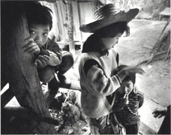 Prostitute Maew Noi, twenty, comforts her younger brother in Pong Chang, a village in northern Thailand. A prostitute since the age of thirteen, she says, I have advice for young girls who need money and are lured to the big city: dont go.